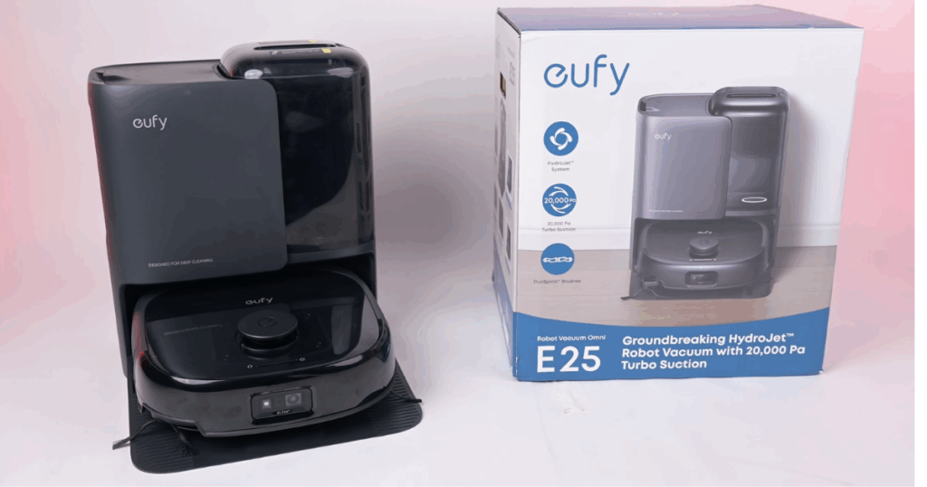Eufy Omni E25 robot vacuum and mop system displayed next to its retail packaging, positioned in its auto-empty dock