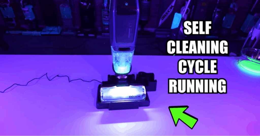 Hard Floor Cleaner Self Cleaning Cycle Running | Vacuum Wars Hard floor cleaner on its dock running a self-cleaning cycle, showing automatic roller and tubing rinse feature for easier maintenance.