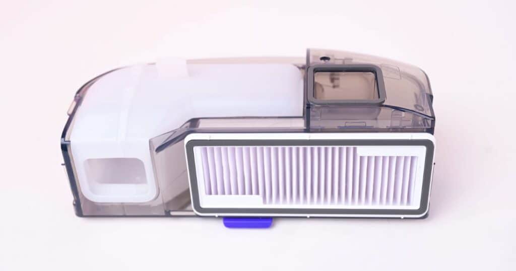 Close-up image of the Narwal Flow’s transparent dual-chamber dustbin and filter assembly.