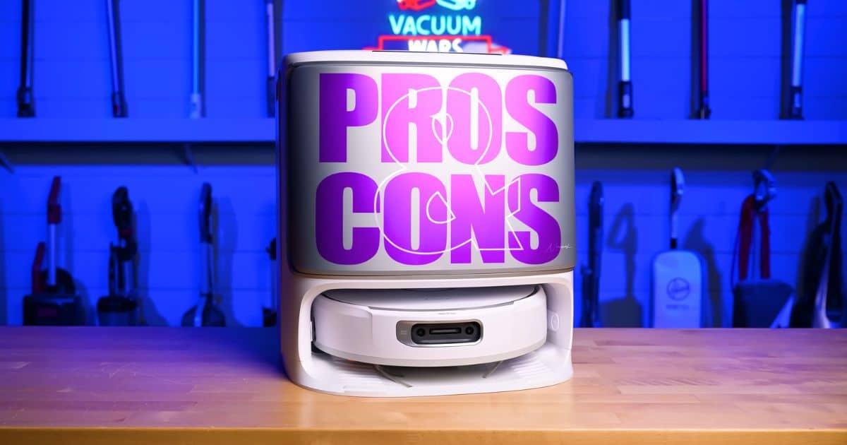Front view of the Narwal Flow robot vacuum inside its docking station with bold “Pros Cons” text displayed across the front, photographed in a blue-lit studio.