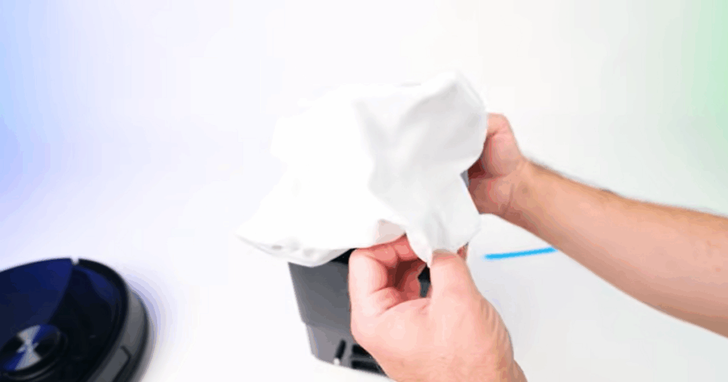 Hands holding the disposable dust bag from the Roborock Q10 S5+ auto-empty dock, which can hold up to 2.7 liters of debris and lasts up to seven weeks before replacement.
