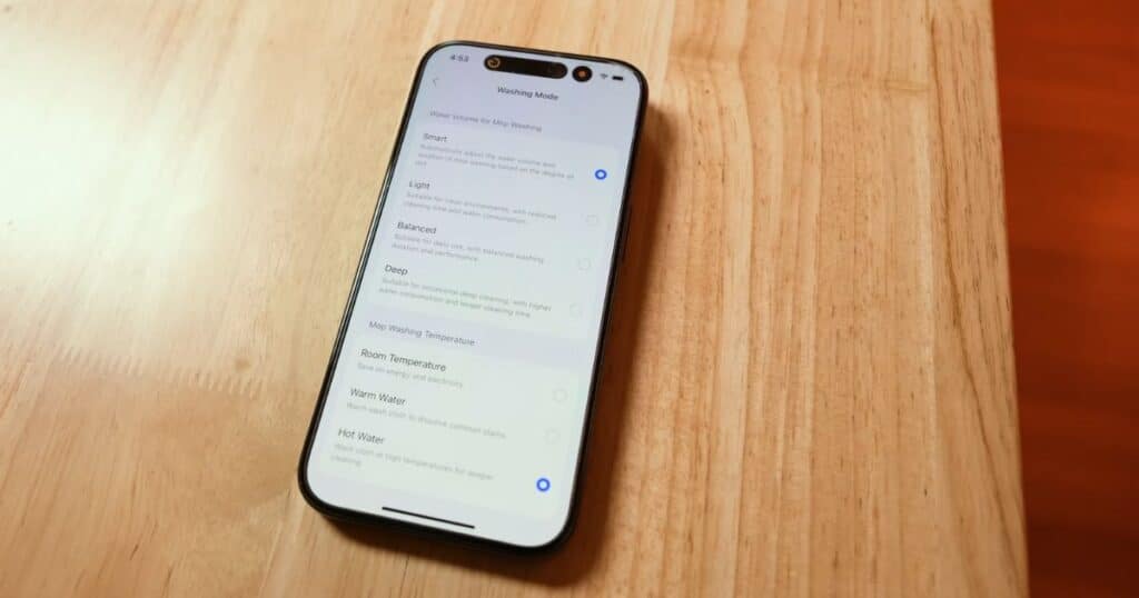 Smartphone screen showing Roborock app washing mode options, including Smart, Light, Balanced, Deep, and temperature settings.