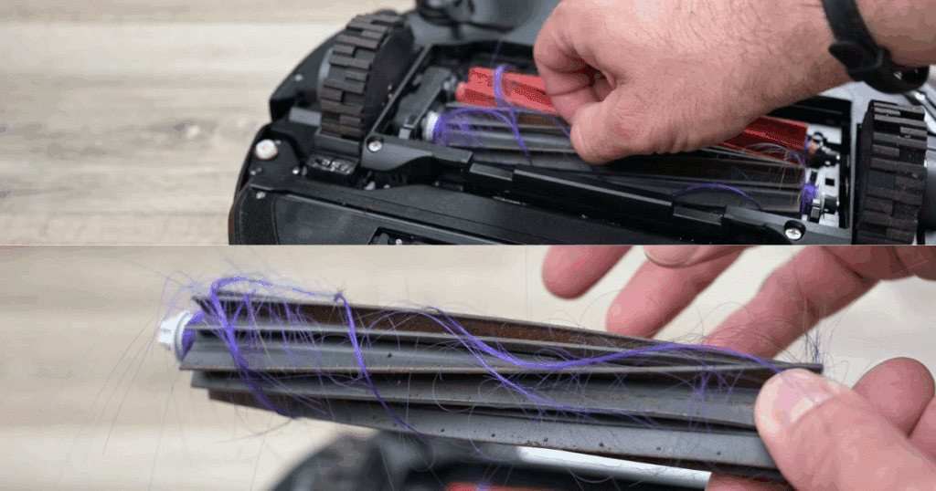 A close up of a hand removing hair from the main brush of a Roborock S8 Max Ultra, a weekly maintenance habit we recommend
