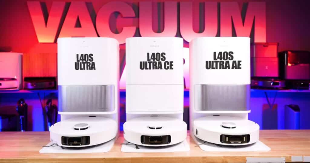 Studio photo showing three Dreame robot vacuum and dock systems side by side on a wooden table, labeled from left to right as L40S Ultra, L40S Ultra CE, and L40S Ultra AE, with a colorful “VACUUM” backdrop behind them.