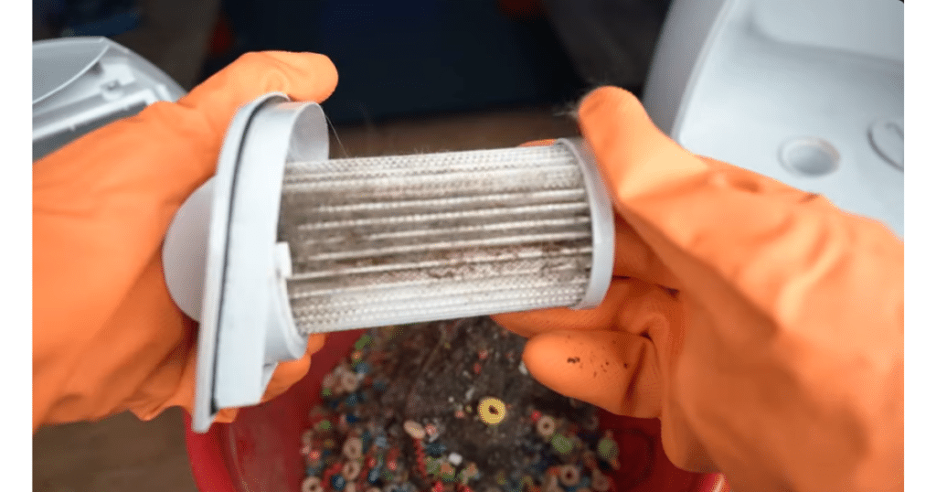 EyeVac Touchless Vacuum Filters | Vacuum Wars Dirty EyeVac vacuum filter being removed and inspected, showing debris and hair buildup that requires regular cleaning.