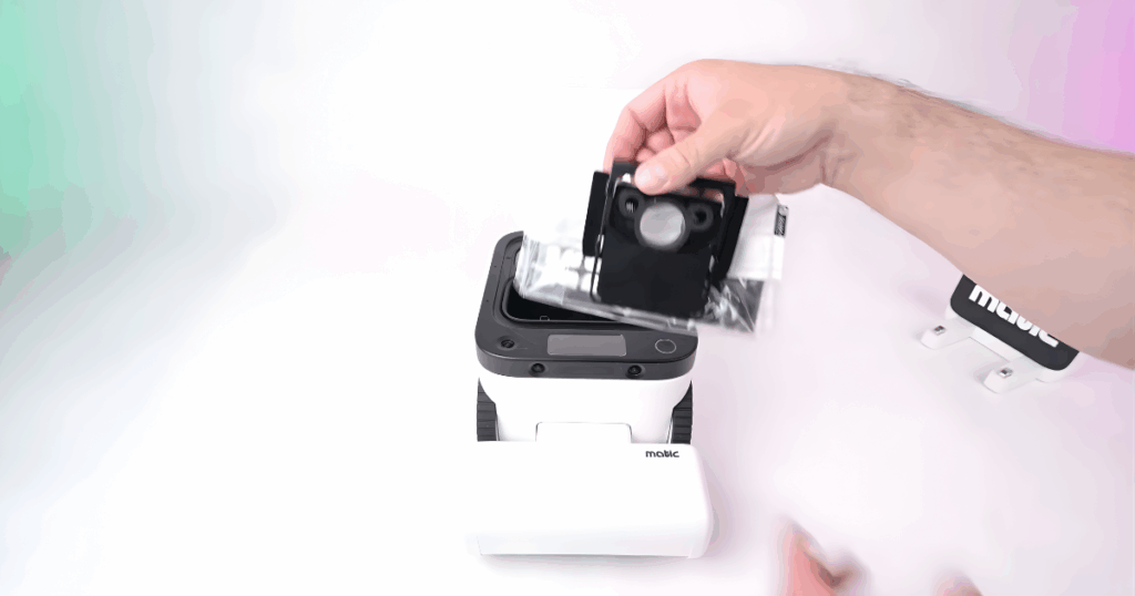 Matic specialized dustbag | Vacuum Wars Hand installing the Matic robot vacuum’s specialized dust bag, which stores dirty mop water and debris instead of using a traditional onboard tank.