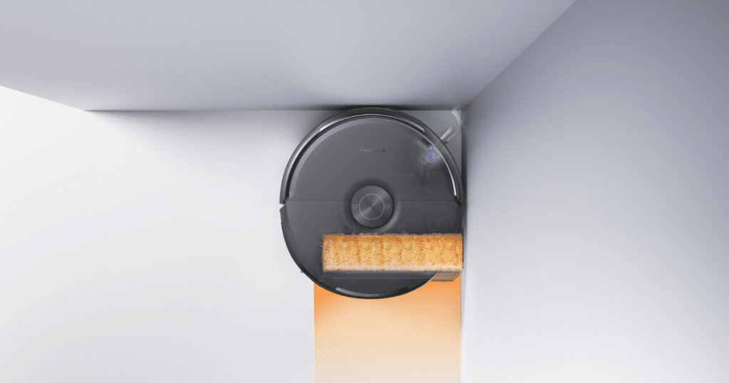 Narwal Flow 2 edge mop | Vacuum Wars Narwal Flow 2 robot vacuum mopping near a wall, showing EdgeReach mop extension and carpet protection shield.