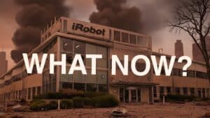 irobot-roomba-bankruptcy-picea-acquisition | Vacuum Wars imagined scenario of the iRobot Headquarters in disarray with "What Now?" across the forefront.