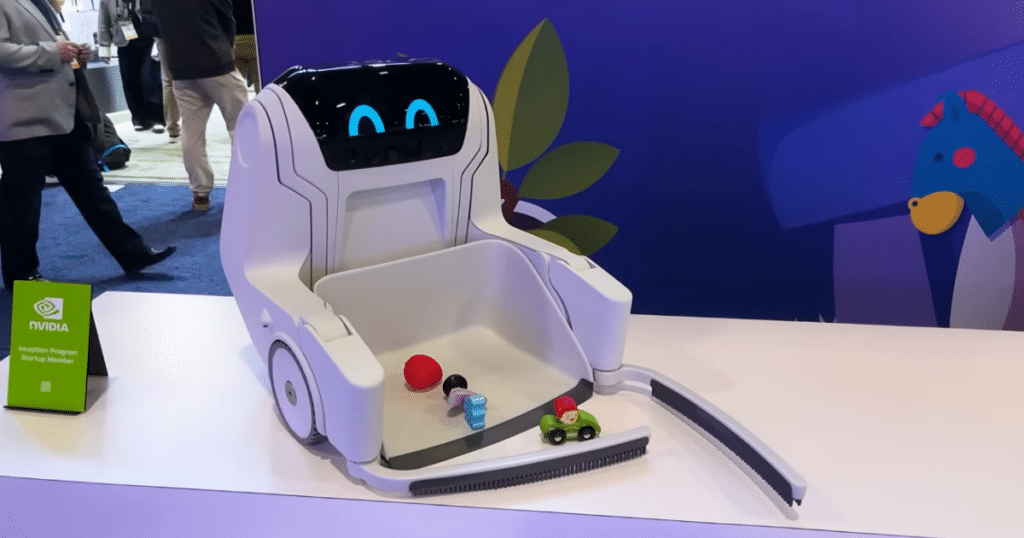 Clutterbot at CES 2026 | Vacuum Wars Clutterbot Rovie clutter-cleaning robot displayed at CES, shown collecting small toys into its front-mounted bin.