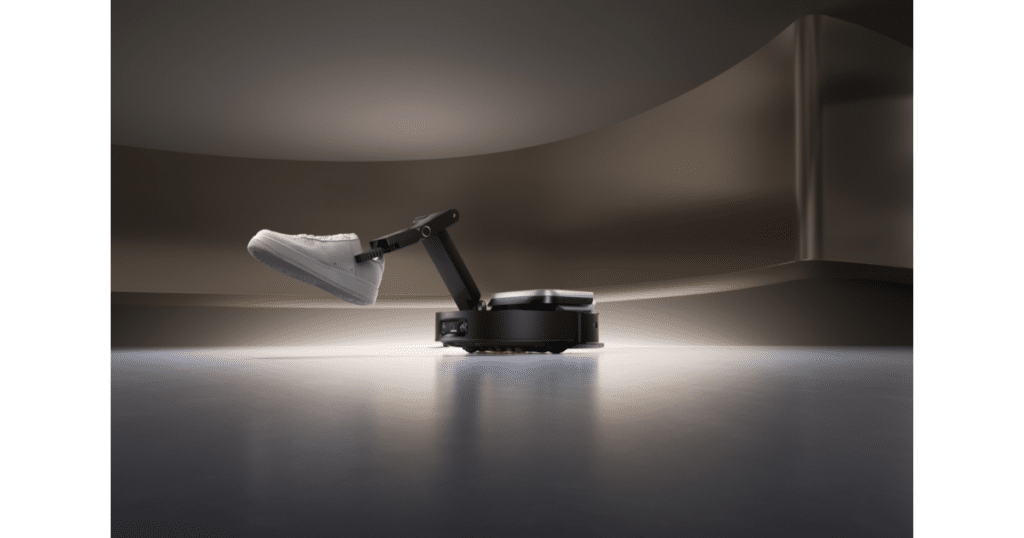 Dreame Cyber 10 Ultra carrying object | Vacuum Wars Robot vacuum with a robotic arm lifting an object, illustrating automated clutter handling and tool interaction