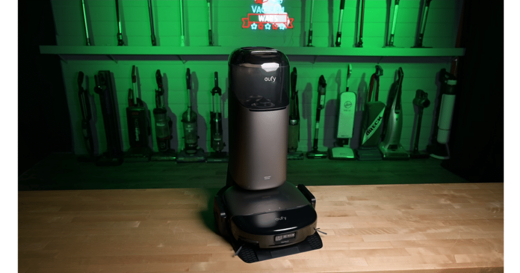 Eufy Omni S2 Robot Vacuum and Mop Combo at Vacuum Wars | Vacuum Wars Eufy Omni S2 robot vacuum and self-cleaning dock displayed in the Vacuum Wars studio with other vacuum models in the background.