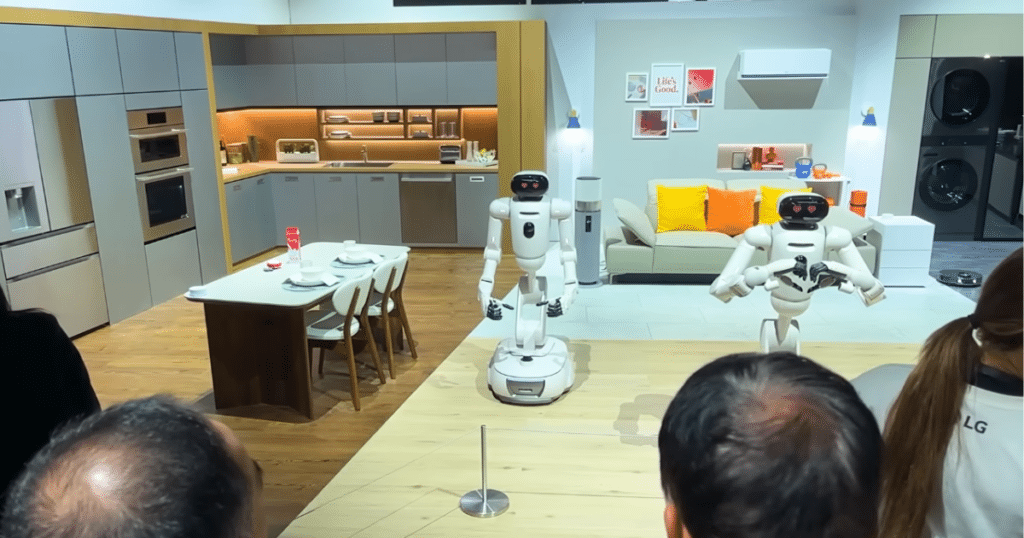 LG at CES 2026 | Vacuum Wars LG CLOid home-assistant robots demonstrated in a staged kitchen and living room environment at CES.