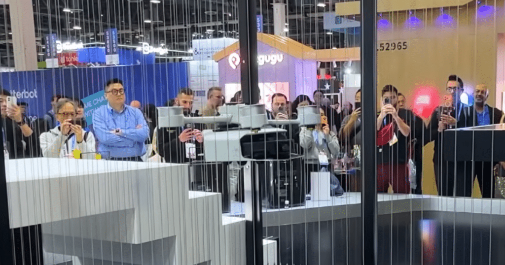 MOVA Pilot 70 at CES | Vacuum Wars MOVA Pilot 70 prototype drone module demonstrated at CES, lifting and transporting a robot vacuum while attendees watch.