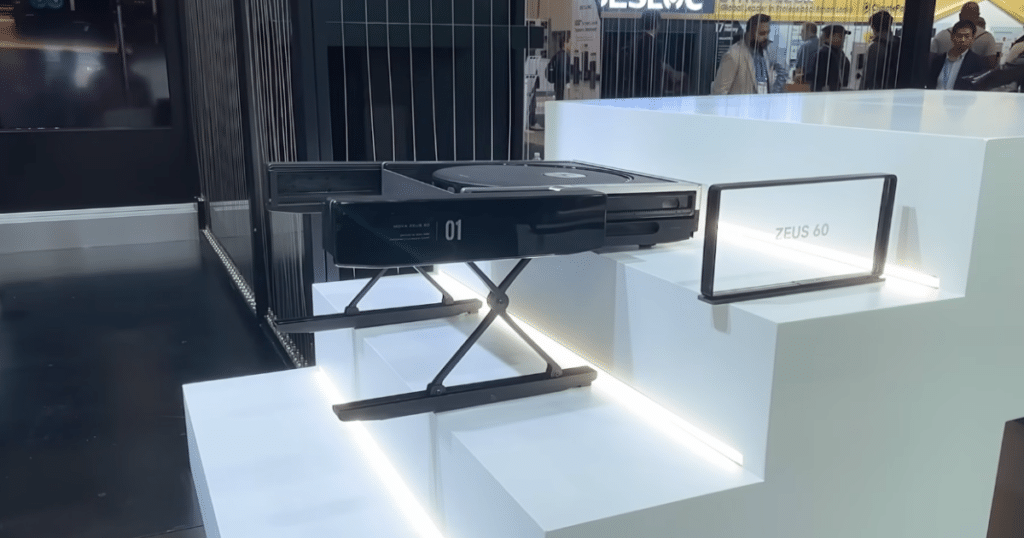 MOVA Zeus 60 at CES 2026 | Vacuum Wars MOVA Zeus 60 stair-climbing robot vacuum module displayed on a stepped platform at CES.