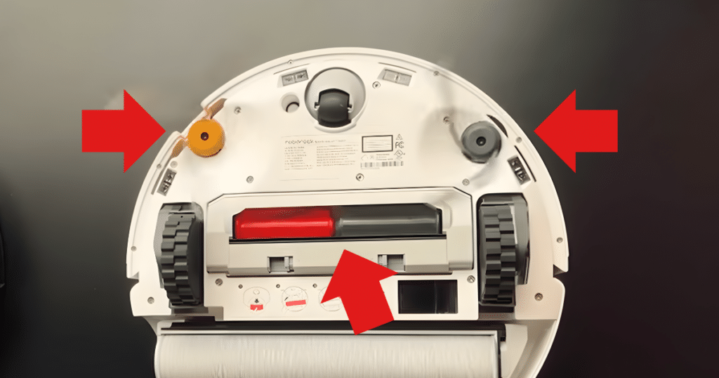 Roborock Qrevo Curv 2 Flow brushes | Vacuum Wars Underside of the Roborock Qrevo Curv 2 Flow showing the DuoDivide anti-tangle main brush and dual Lifting Arc side brushes designed to reduce hair wrapping.