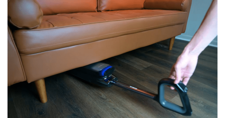 Tineco Floor One S9 Artist Steam cleaning under a couch using its 180-degree lay-flat design
