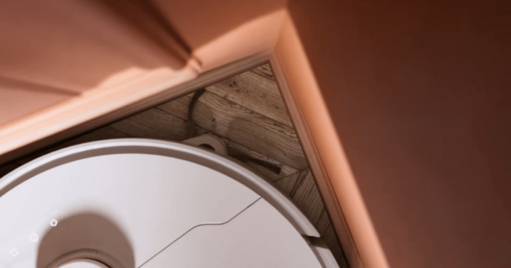 MOVA E40 Ultra V P10 Pro Ultra corner clean | Vacuum Wars MOVA P10 Pro Ultra robot vacuum using its extendable side brush to sweep debris from a tight corner along baseboards.