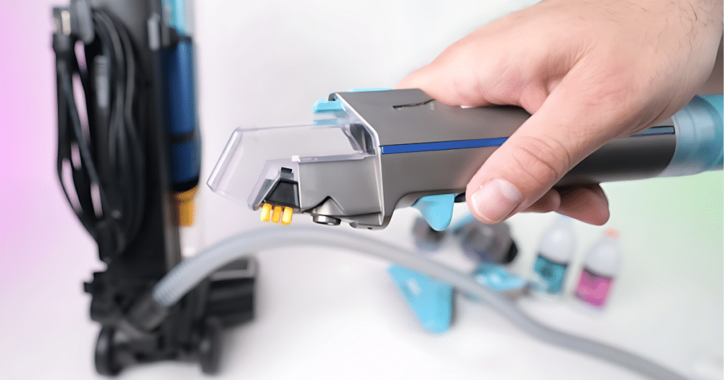 CarpetXpert Ex301 Buit in Mini | Vacuum Wars Close-up of the Shark EX301 CarpetXpert built-in mini stain eliminator tool on the hose used for spot cleaning small stains.