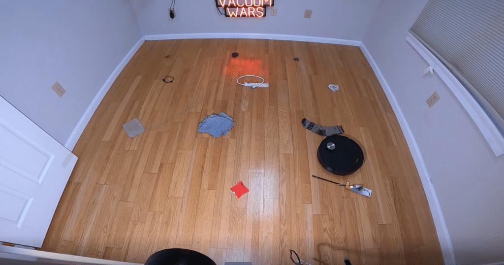 Dreame X60 Max Ultra Complete OA Evaluations | Vacuum Wars Dreame X60 Max Ultra Complete navigating a hardwood floor obstacle course with common household items during Vacuum Wars avoidance testing