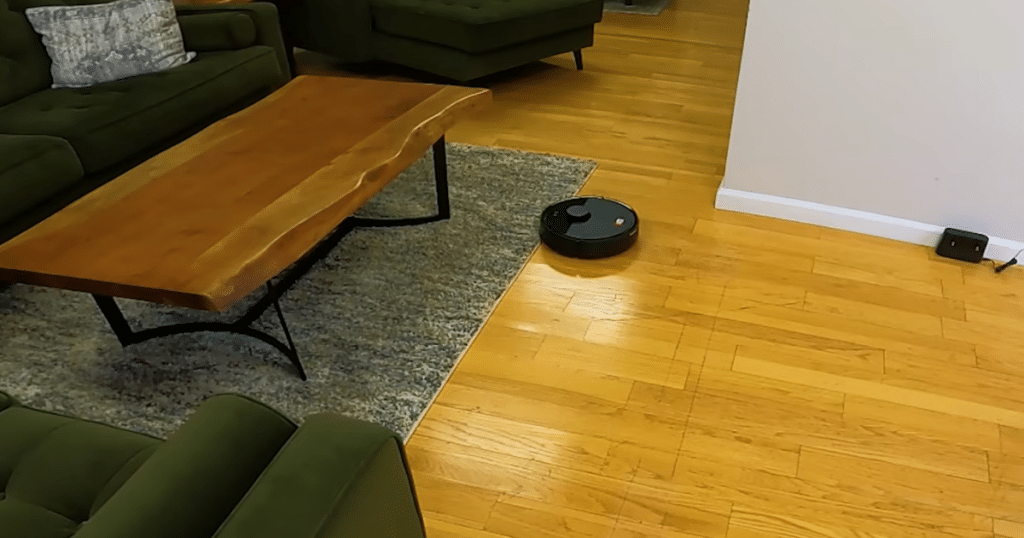 Roborock Q7 L5 Vs M5 vacuum only | Vacuum Wars Roborock Q7 robot vacuum cleaning hardwood floor near carpet showing mop pad cannot lift on rugs