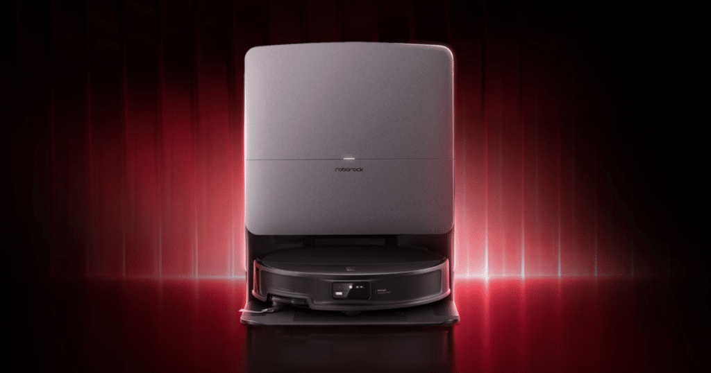 Roborock Saros 20 robot vacuum sitting in its automated docking station against a red illuminated background.