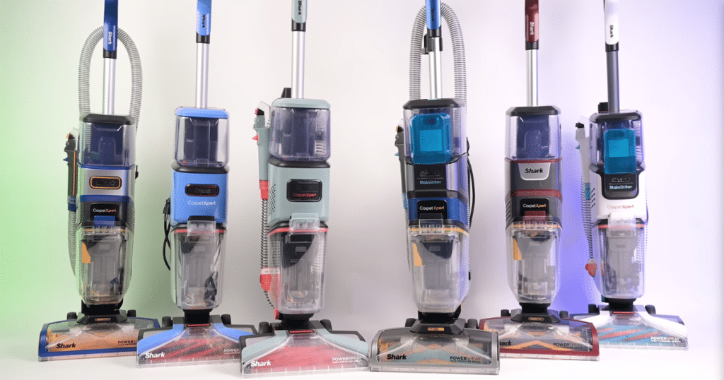 Shark CarpetXpert Lineup at the Vacuum Wars Studio | Vacuum Wars Several Shark CarpetXpert carpet cleaner models from different generations displayed side by side for comparison.