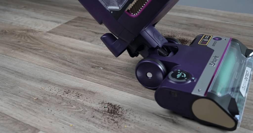 Shark PowerDetect Upright Hard Floor Pickup 2 | Vacuum Wars Shark PowerDetect Upright Vacuum after successfully completing a sweep across large and small debris on a hard floor surface.