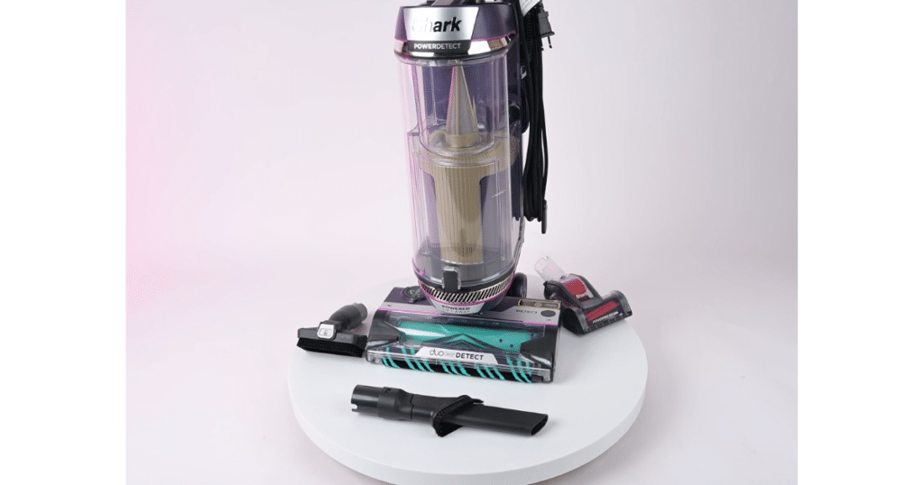 Shark PowerDetect Upright shown with attachment set | Vacuum Wars Shark PowerDetect upright vacuum displayed with included attachments on a white platform