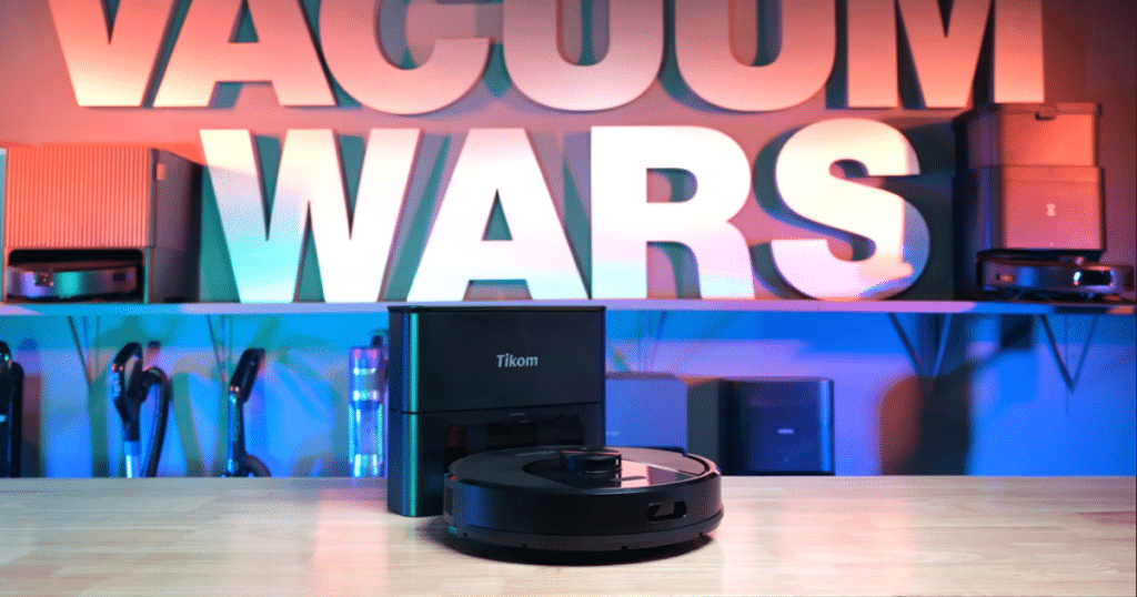Tikom L8000 at the Vacuum Wars Studio | Vacuum Wars Tikom L8000 Plus robot vacuum with auto-empty base station displayed on a table in the Vacuum Wars studio.