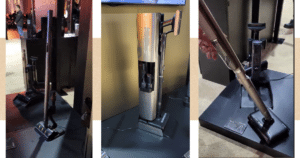 Three cordless stick vacuum cleaners on display in a showroom.