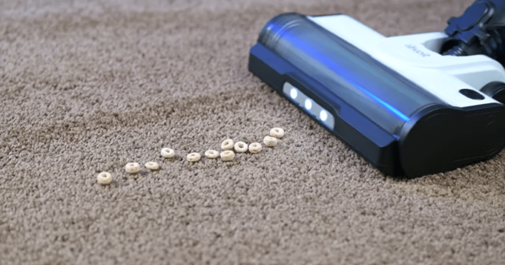 Levoit LVAC 200 Carpet 1 | Vacuum Wars Levoit LVAC 200 cordless vacuum approaching large debris on a carpet.