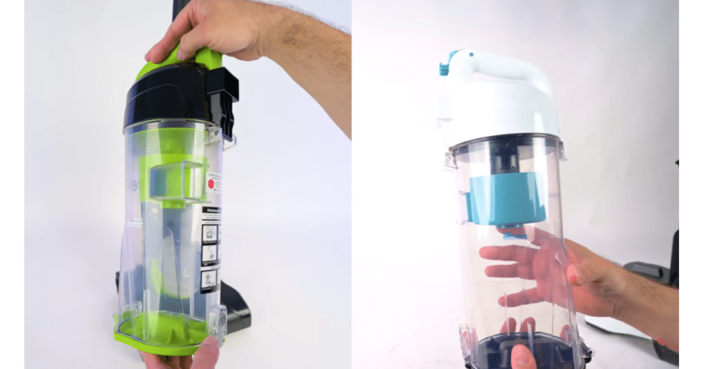 Lightweight budget bin sizes | Vacuum Wars Close-up of two upright vacuum dustbins being held and removed, with the Eureka Airspeed E4 bin on the left and the Amazon Basics bin on the right, showing differences in size and design.