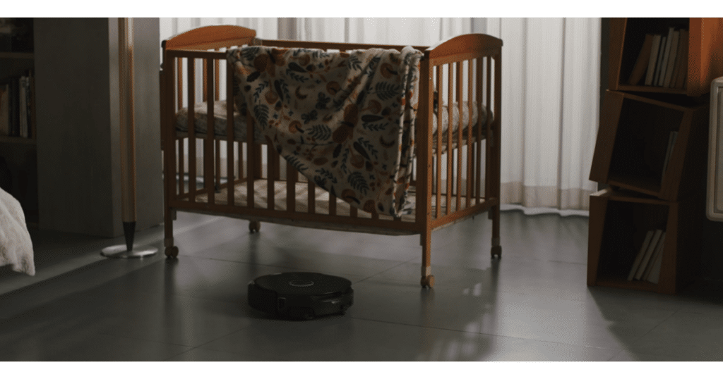Narwal FLow 2 crib quiet | Vacuum Wars Narwal Flow 2 robot vacuum cleaning quietly near a baby crib with low-noise adaptive mode
