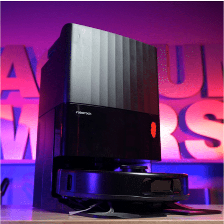 Roborock Qrevo S Pro in studio 450 | Vacuum Wars Desktop 3D printer with a tall black enclosure on a stand, illuminated by purple backlight behind it.
