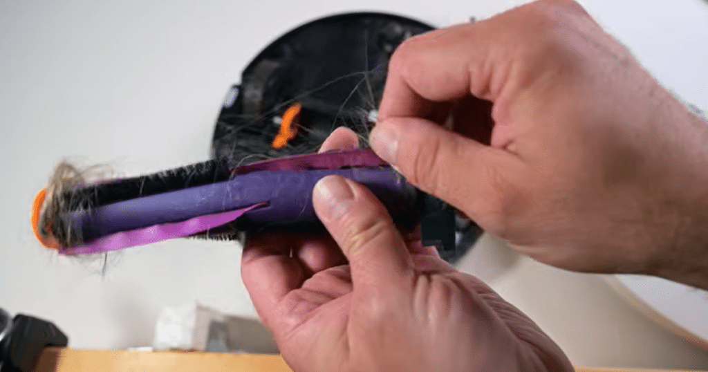 Shark Powerdetect UV Reveal tangle | Vacuum Wars Robot vacuum brush roll with tangled hair showing 29% hair wrap in a 7-inch hair test, compared to 26% average.