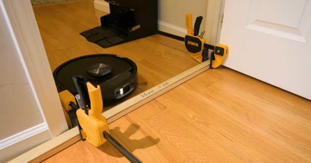 Shark Powerdetect UV Reveal threshold | Vacuum Wars Shark PowerDetect UV Reveal robot vacuum attempting to climb threshold barriers, clearing 19 mm but failing at 25 mm height.