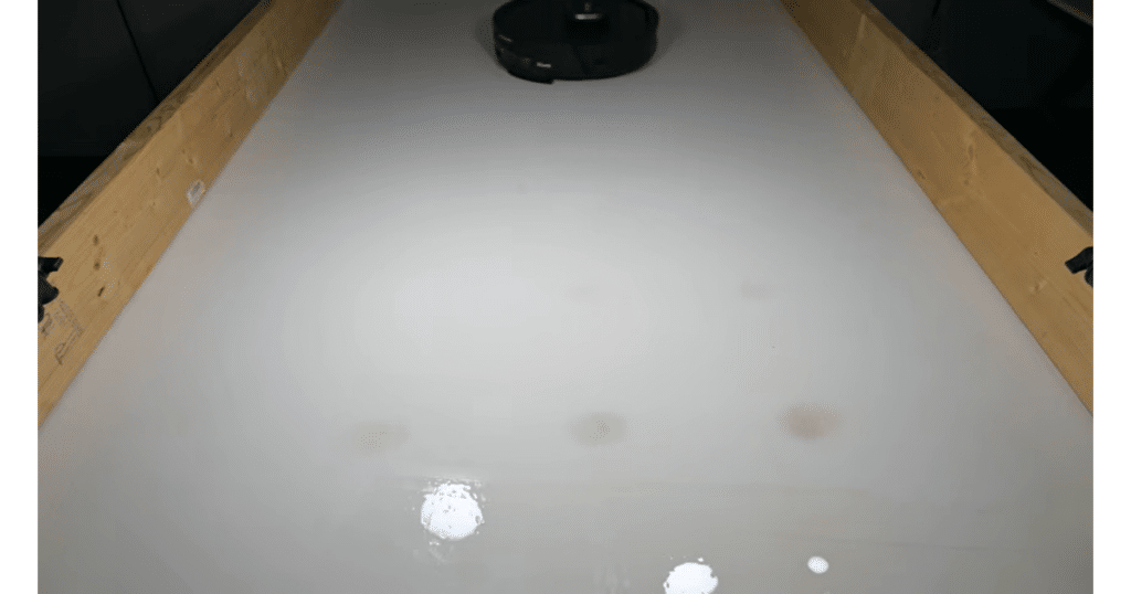 Shark Powerdetect UV Reveal wet floor | Vacuum Wars Wet floor after robot mopping showing visible moisture and light streaking despite using low water setting.