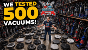 A man standing among 100s of vacuums.
