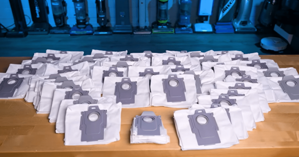 dyson spot + scrub ai bag cost | Vacuum Wars Large collection of disposable robot vacuum bags illustrating ongoing consumable costs compared to Dyson’s bagless auto-empty system