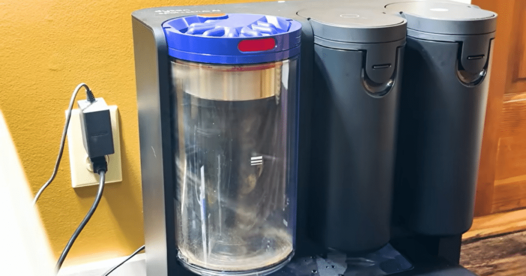 dyson spot + scrub ai bagless bin | Vacuum Wars Dyson Spot+Scrub AI bagless auto-empty dock bin showing separated pet hair after nearly two weeks of use in a multi-pet home