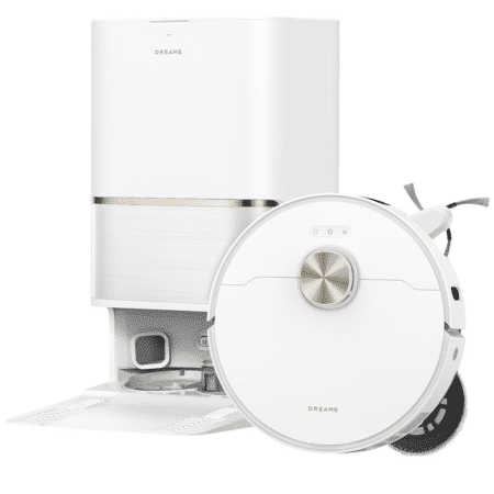 image | Vacuum Wars White circular Dreame robotic vacuum cleaner with its charging dock and a tall white rectangular appliance behind it in a minimal setting.