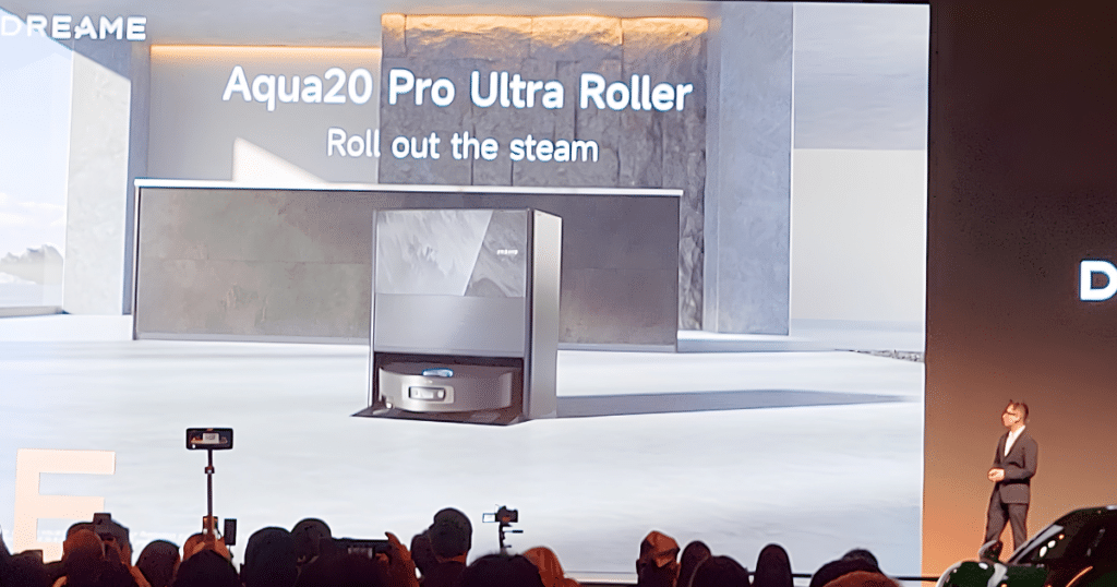 Dreame Aqua 20 at Dreame Next | Vacuum Wars Dreame presents the Aqua 20 Pro Ultra Roller robot vacuum onstage at a product event.