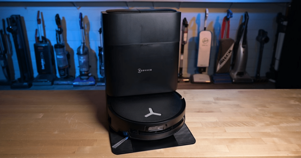 Ecovacs Deebot T80S OMNI at Vacuum Wars | Vacuum Wars Ecovacs Deebot T80S OMNI robot vacuum and auto-empty dock positioned on a hardwood floor in the Vacuum Wars testing studio.
