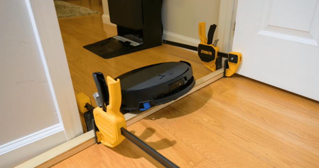 Ecovacs Deebot T90 Pro Omni Threshold Test | Vacuum Wars Ecovacs T90 Pro Omni robot vacuum climbing over a raised doorway threshold during Vacuum Wars’ real-world threshold test.