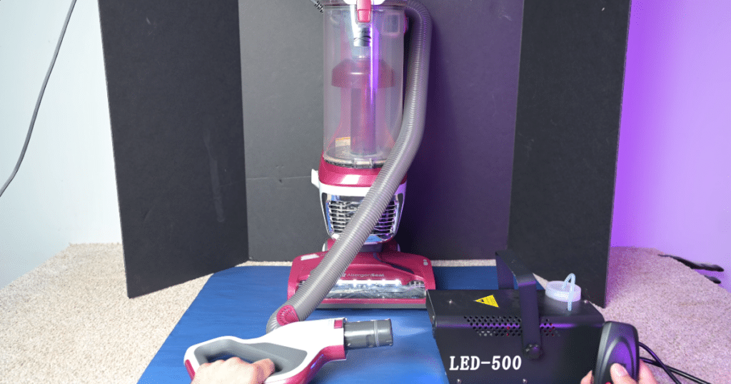 Kenmore Bagless DU5092 Filtration | Vacuum Wars Kenmore DU5092 upright vacuum undergoing a sealed filtration fog test with an LED-500 particle detection device in a testing environment.
