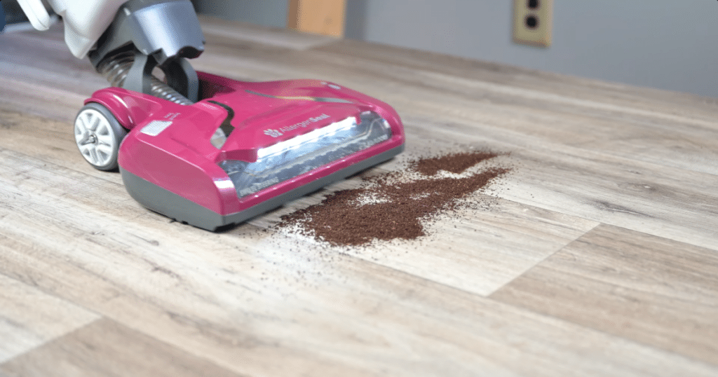 Kenmore Bagless DU5092 Hard Floor Debris 1 | Vacuum Wars Kenmore vacuum approaching fine debris on a hard floor.