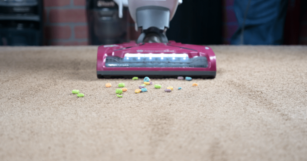 Kenmore Bagless DU5092 large debris on carpet 1 | Vacuum Wars Kenmore vacuum approaching large debris on a carpet.