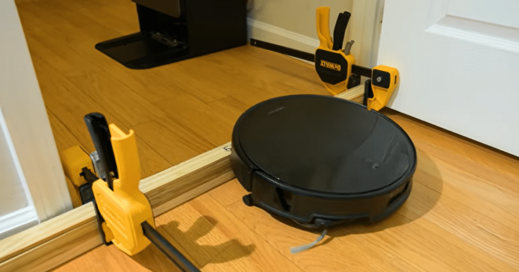 Roborock Saros 20 threshold test | Vacuum Wars Roborock Saros 20 robot vacuum climbing a tall single-step threshold during Vacuum Wars testing. The Saros 20 successfully crossed a 57 mm (2.24-inch) barrier, surpassing previous threshold climbing records held by the MOVA Z60 and Dreame X60.