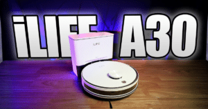 iLife As30 Robot Vacuum Review | Vacuum Wars ILIFE A30 robotic vacuum on a wooden surface with its charging dock in the background, purple lighting.
