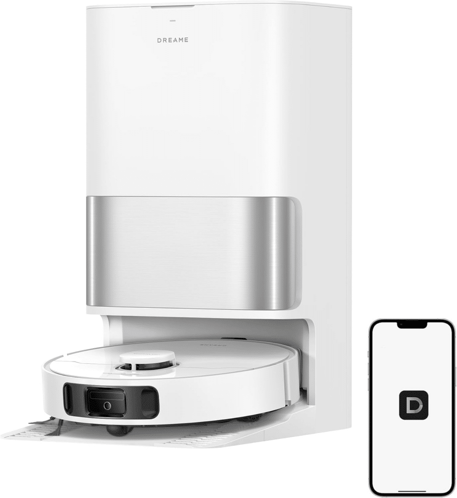 image | Vacuum Wars White robot vacuum dock with a metal charging base and a smartphone showing a mobile app nearby.